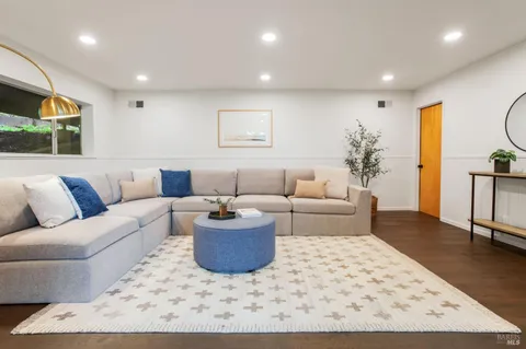 a living room with furniture and a rug