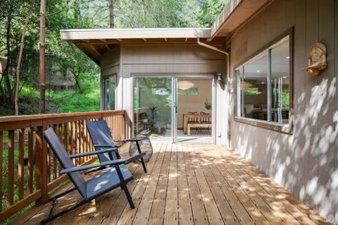a view of backyard with outdoor seating and wooden floor