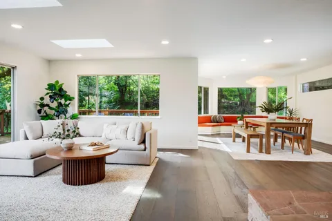 a living room with furniture a patio and a garden