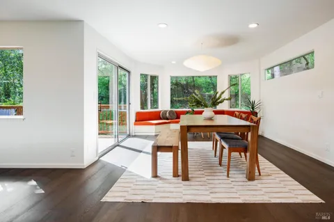 a dining room with furniture a rug and wooden floor