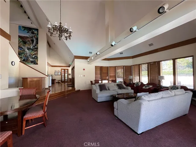 a living room with fireplace furniture and a large window