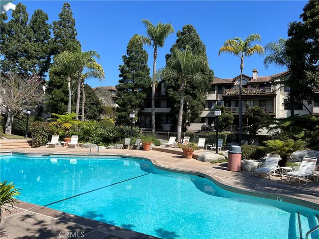 a view of a house with swimming pool and sitting area