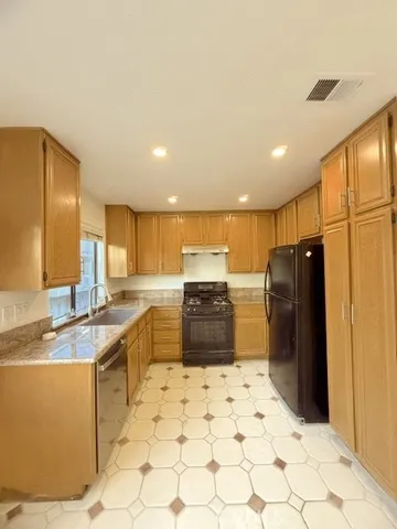 a large kitchen with a large counter top appliances and cabinets