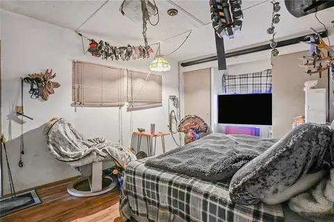 a bed room with a bed and a television