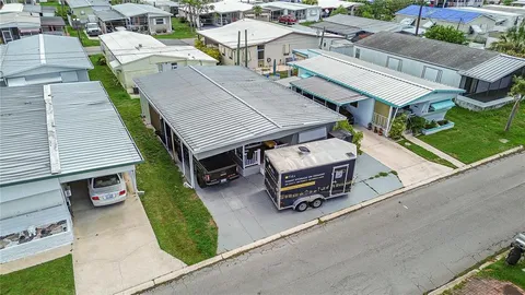 an aerial view of a house with garden space and street view