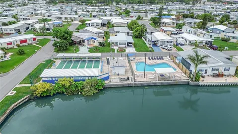 an aerial view of residential houses with outdoor space and lake view