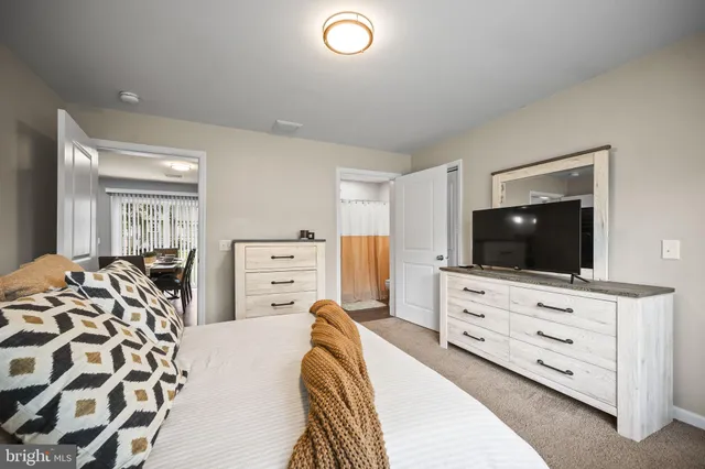 a bedroom with a bed and a flat screen tv in it