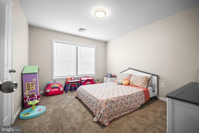 a bedroom with bed and a window