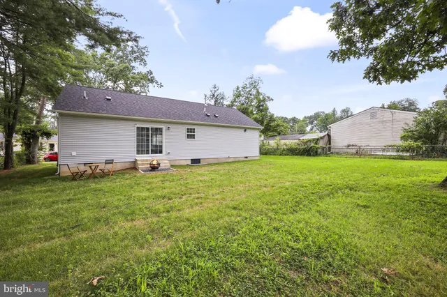 a front view of house with yard and trees