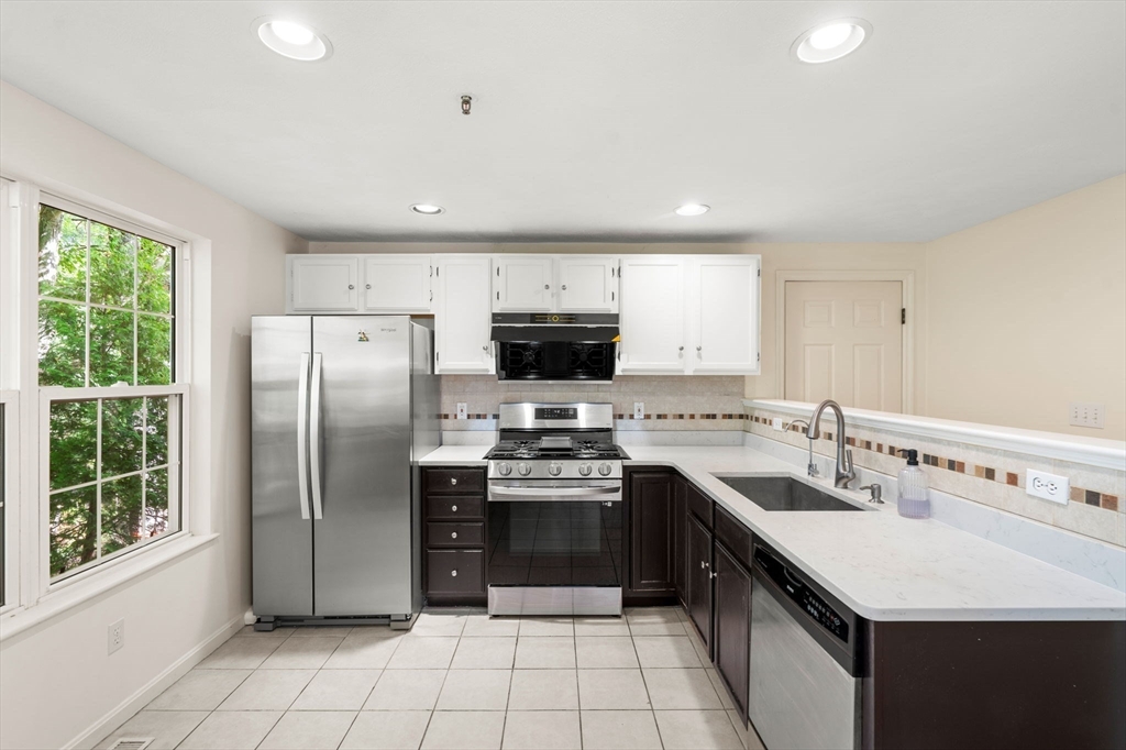 58 Meadowood Road North Andover, MA 01845 - Photo 11 of 31 a kitchen with stainless steel appliances granite countertop a sink stove and refrigerator