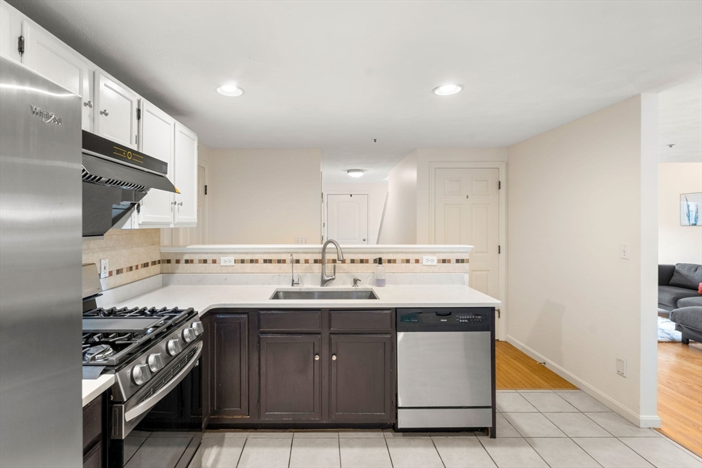 58 Meadowood Road North Andover, MA 01845 - Photo 14 of 31 a kitchen with a sink stove and cabinets