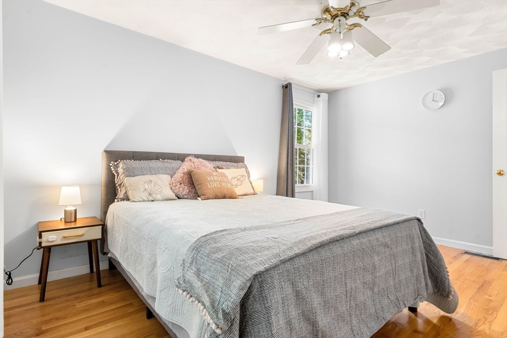 58 Meadowood Road North Andover, MA 01845 - Photo 19 of 31 a bedroom with a bed and a chandelier