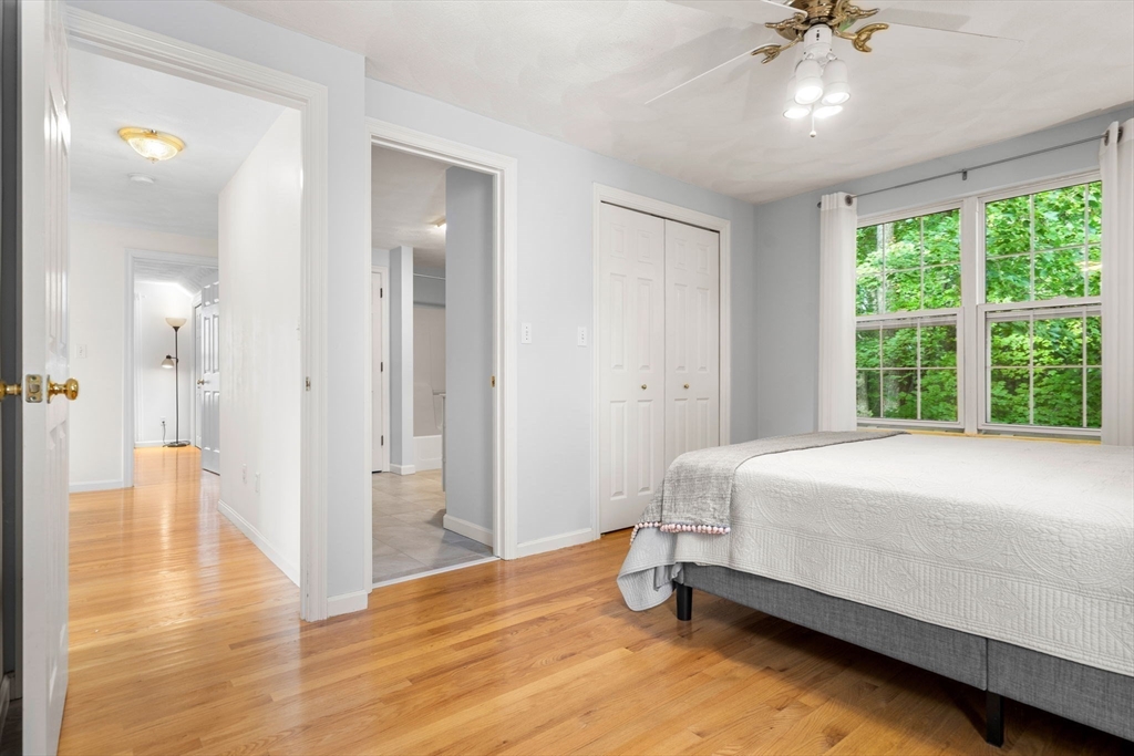 58 Meadowood Road North Andover, MA 01845 - Photo 20 of 31 a spacious bedroom with a bed and a chandelier