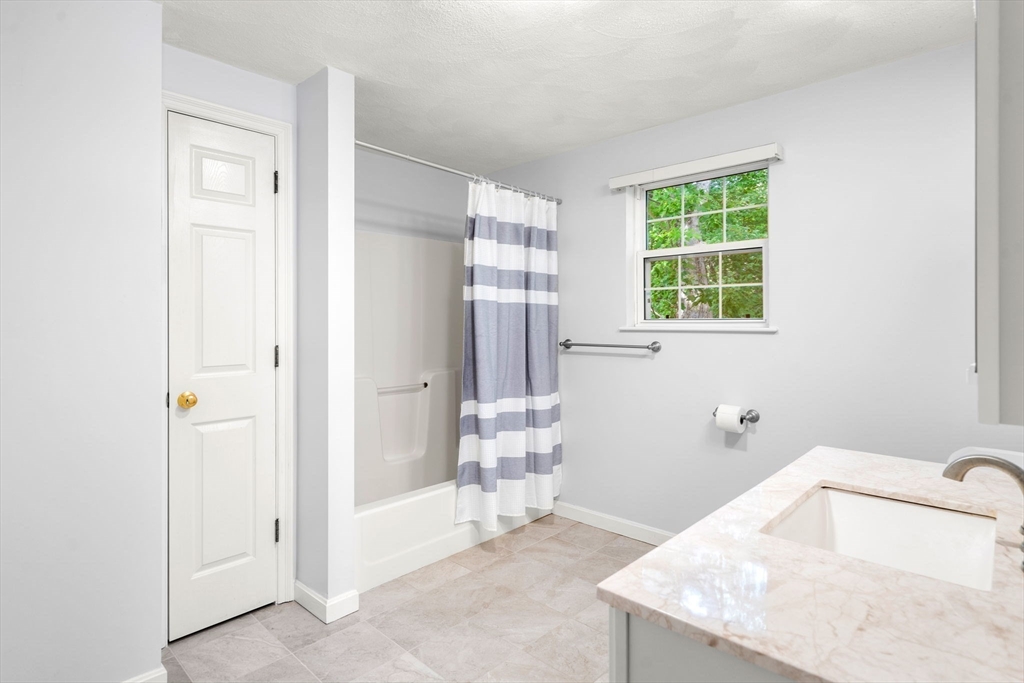 58 Meadowood Road North Andover, MA 01845 - Photo 21 of 31 a bathroom with a granite countertop sink a toilet and shower