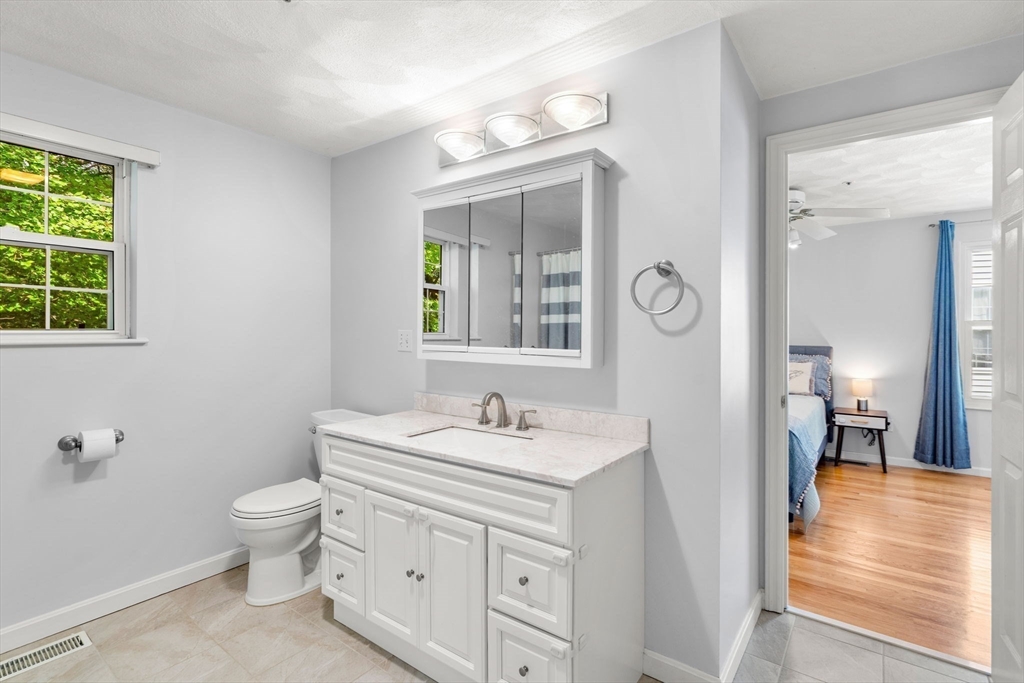 58 Meadowood Road North Andover, MA 01845 - Photo 22 of 31 a bathroom with a sink a toilet and a mirror