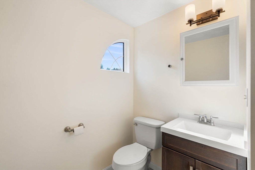 58 Meadowood Road North Andover, MA 01845 - Photo 25 of 31 a bathroom with a toilet sink vanity and mirror