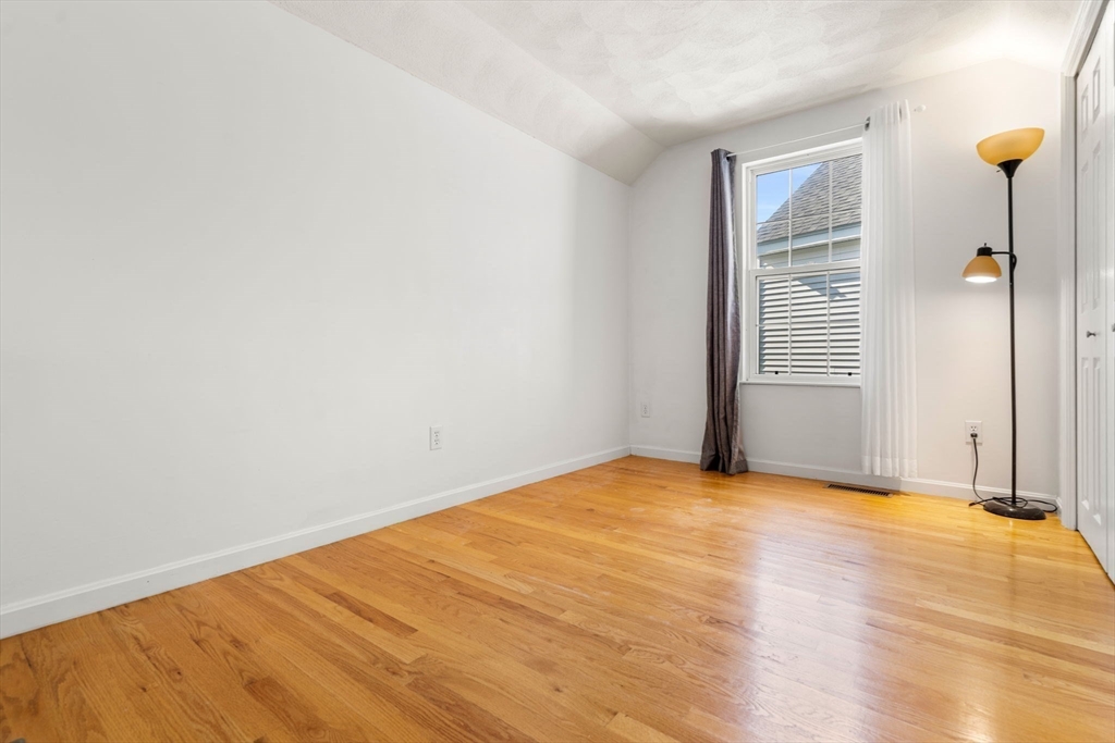 58 Meadowood Road North Andover, MA 01845 - Photo 27 of 31 a view of an empty room with wooden floor and a window