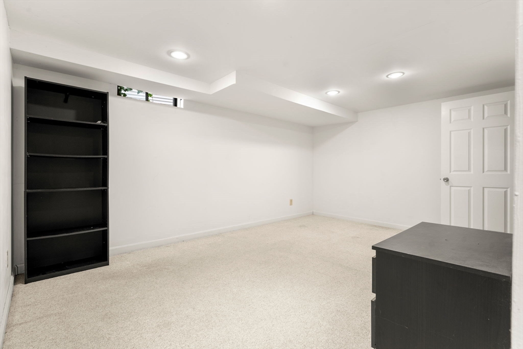 58 Meadowood Road North Andover, MA 01845 - Photo 28 of 31 a view of an empty room with a cabinet and a window