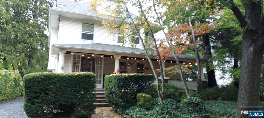 a view of house with outdoor space and garden
