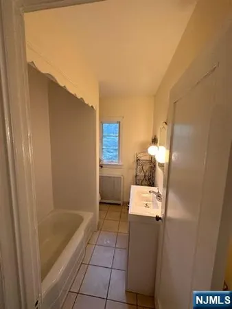 a bathroom with a bathtub and a sink
