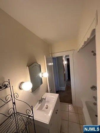 a bathroom with a sink mirror and shower