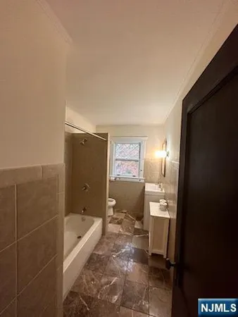 a bathroom with a bathtub and toilet