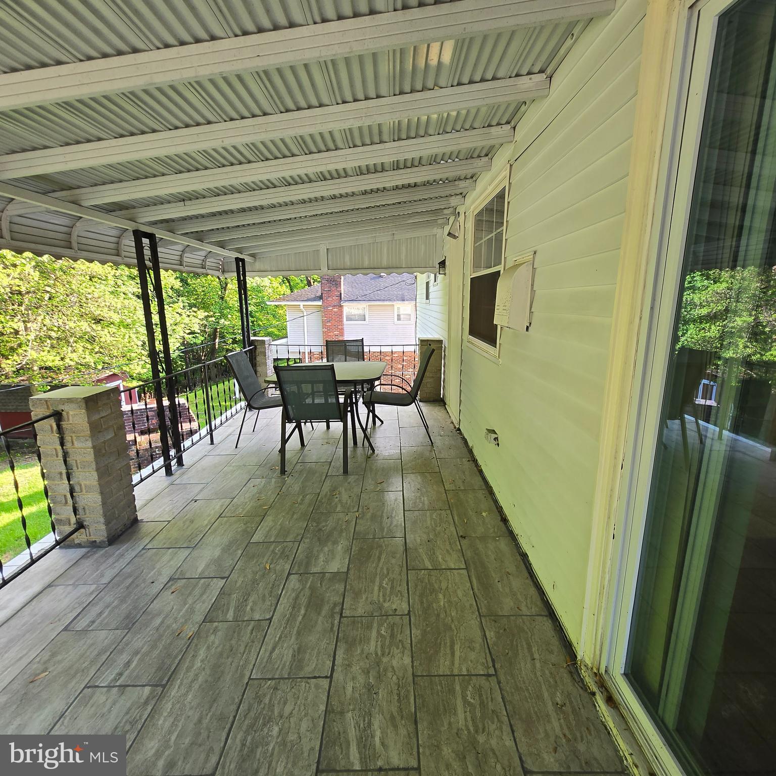 3505 Templar Road Randallstown, MD 21133 - Photo 38 of 40 a view of a patio with table and chairs potted plants with wooden floor