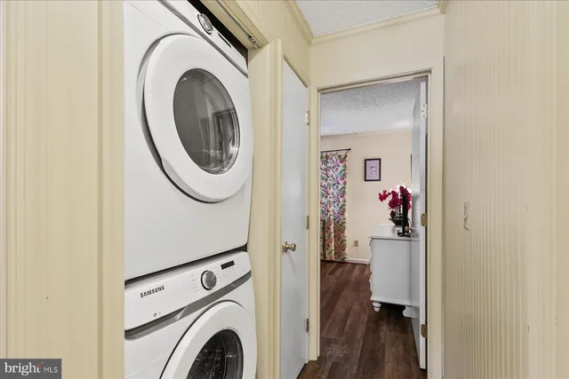 a view of a storage and utility room with dryer and washer