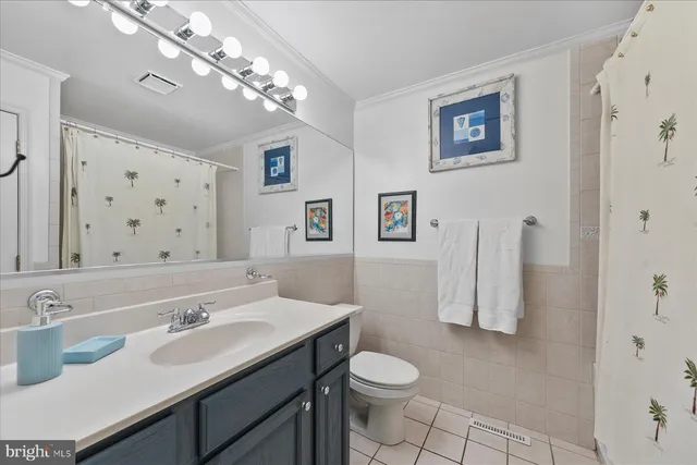 a bathroom with a sink vanity granite toilet and a mirror