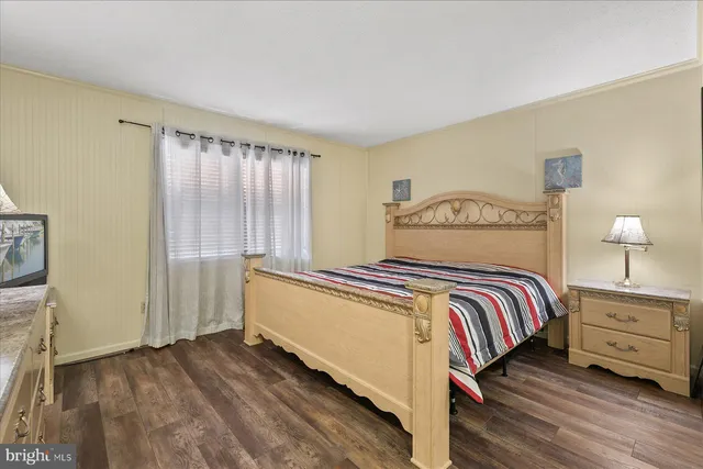 a bedroom with a bed and a night stand