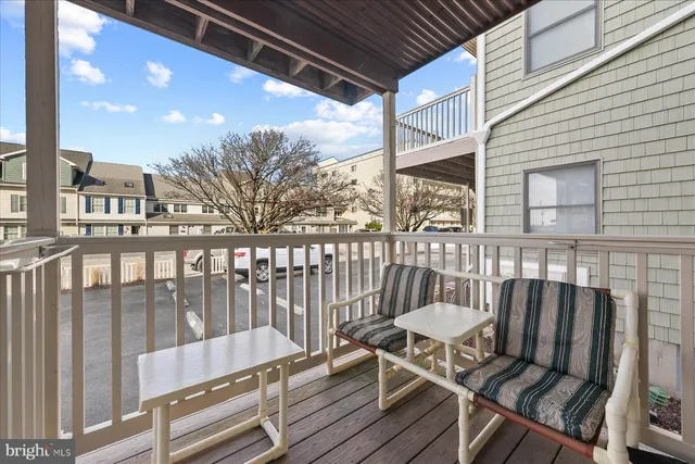 a view of a chair and table on the deck