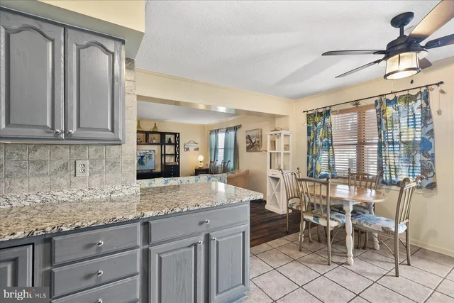 a view of a kitchen with granite countertop cabinets and outdoor view