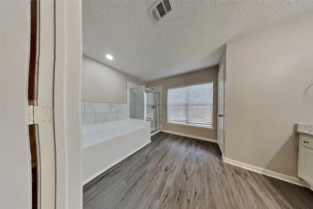 a view of wooden floor in an empty room