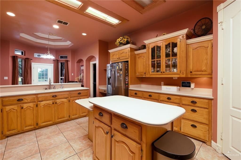 23725 North Val Verde Road Edinburg, TX 78542 - Photo 12 of 36 a kitchen with a table chairs sink and cabinets