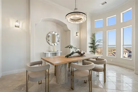 a view of a dining room with furniture and a chandelier