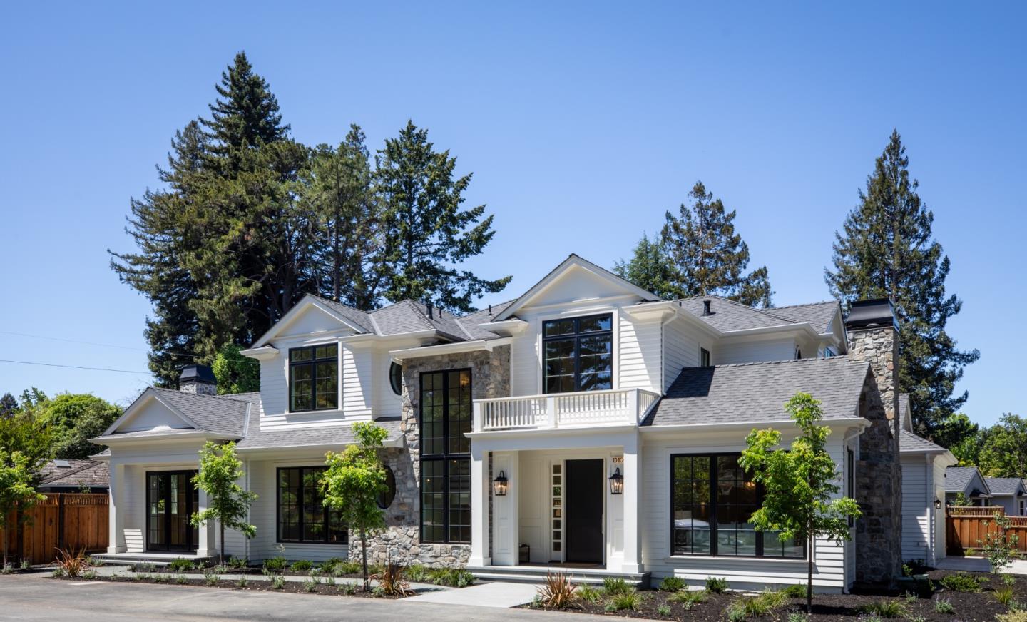 a front view of a white house with a outdoor space