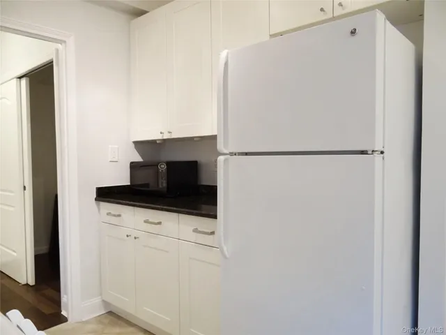 a kitchen with a refrigerator and a stove