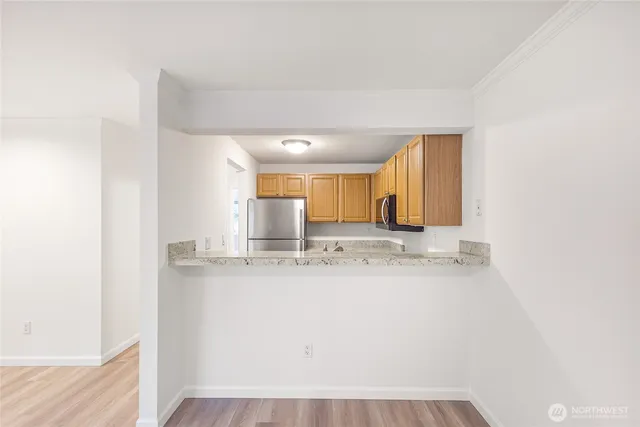 a view of kitchen with wooden floor