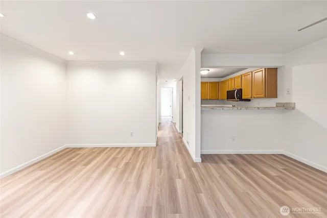 a view of a room with wooden floor and electronic appliances