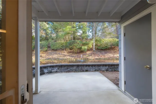 a view of a room with a large window and wooden floor