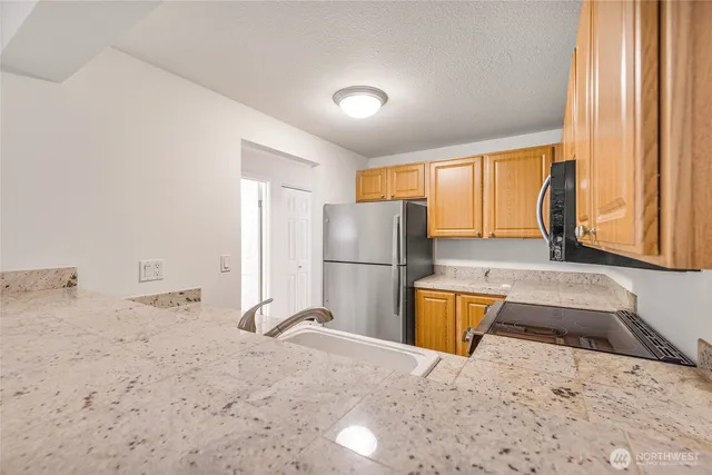 a kitchen with a refrigerator and a sink