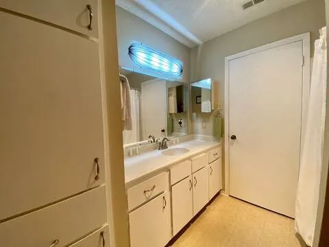 a bathroom with a double vanity sink and a mirror