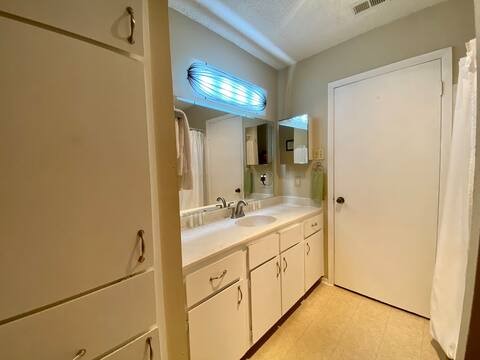 903 The High Road Austin, TX 78746 - Photo 17 of 39 a bathroom with a double vanity sink and a mirror