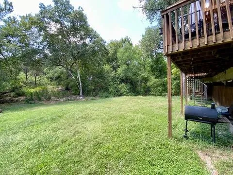 a backyard of a house with table and chairs