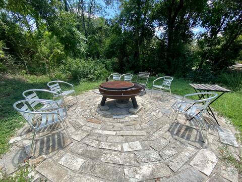 903 The High Road Austin, TX 78746 - Photo 24 of 37 a view of a backyard with table and chairs potted plants and tree