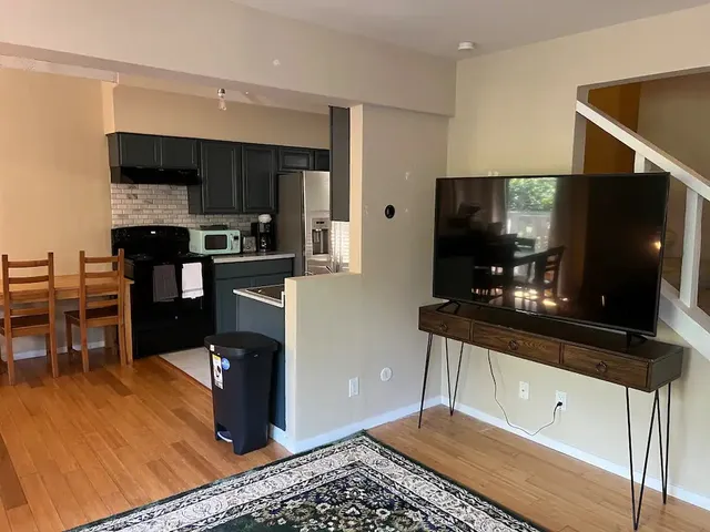 a kitchen with stainless steel appliances kitchen island granite countertop a refrigerator and a stove top oven