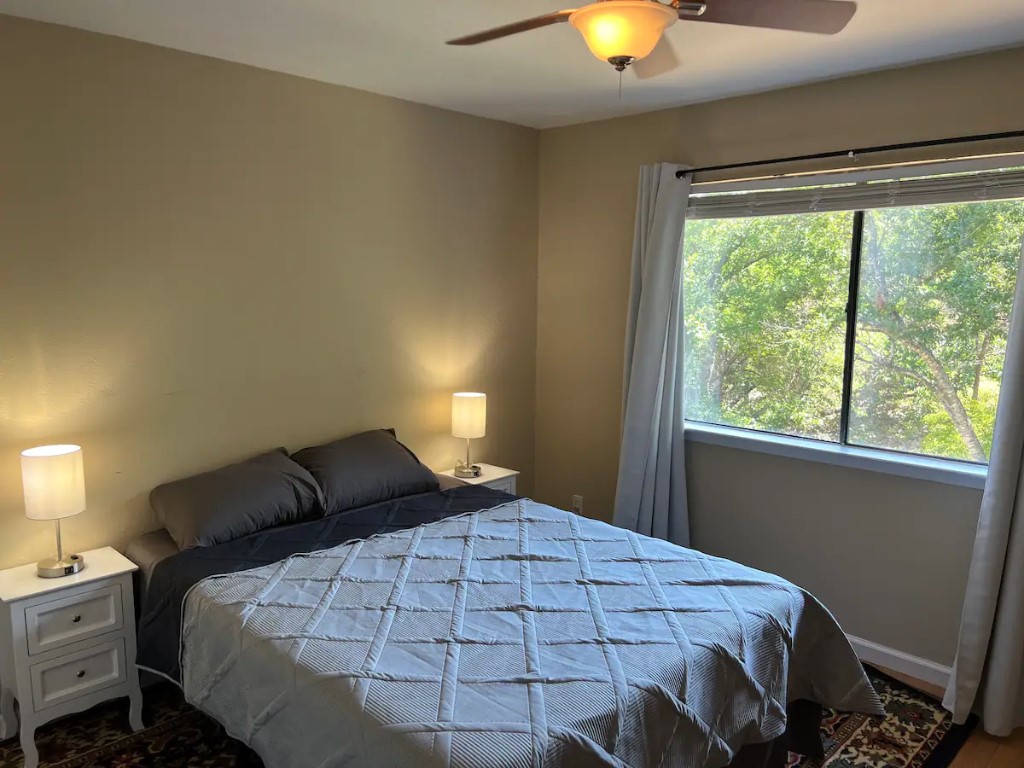 903 The High Road Austin, TX 78746 - Photo 28 of 39 a bedroom with a bed and window