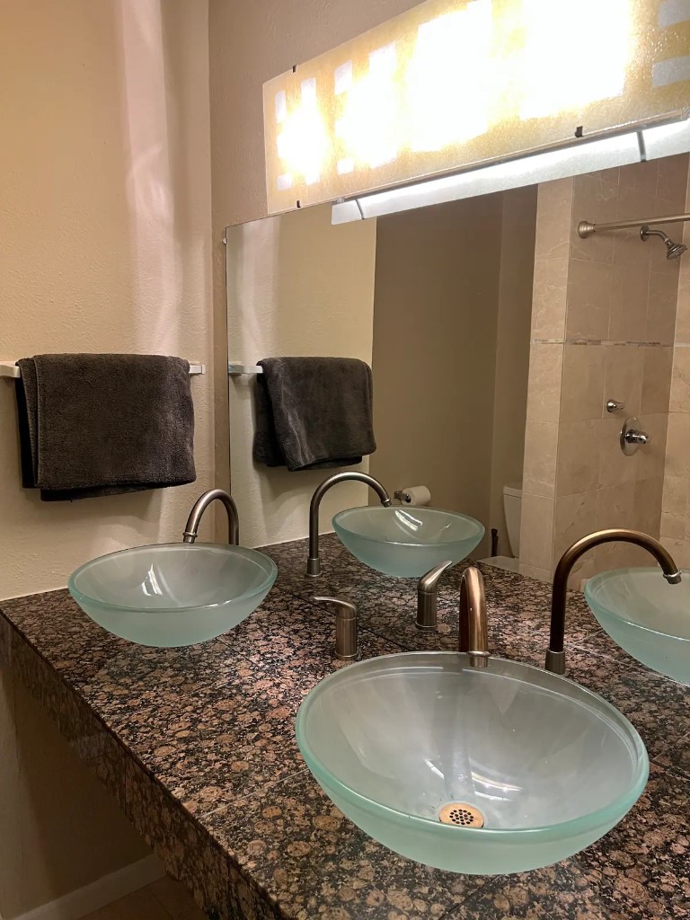 903 The High Road Austin, TX 78746 - Photo 29 of 37 a bathroom with a granite countertop sink and a mirror