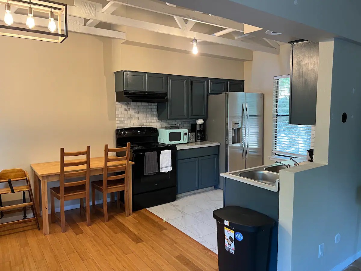 903 The High Road Austin, TX 78746 - Photo 30 of 37 a kitchen with stainless steel appliances kitchen island granite countertop a refrigerator and a stove top oven