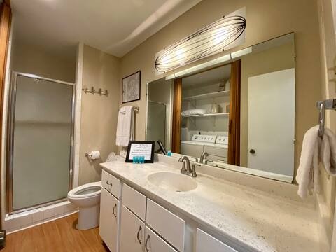 903 The High Road Austin, TX 78746 - Photo 4 of 39 a bathroom with a granite countertop sink toilet and shower